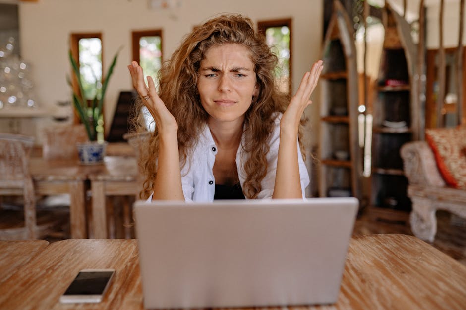 HR professional using laptop and smartphone