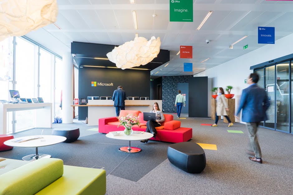 business professional greeting visitor in modern office lobby