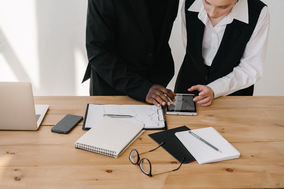 business professionals analyzing financial forecasts on computer