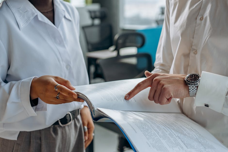 business professionals reviewing lease documents and floor plans