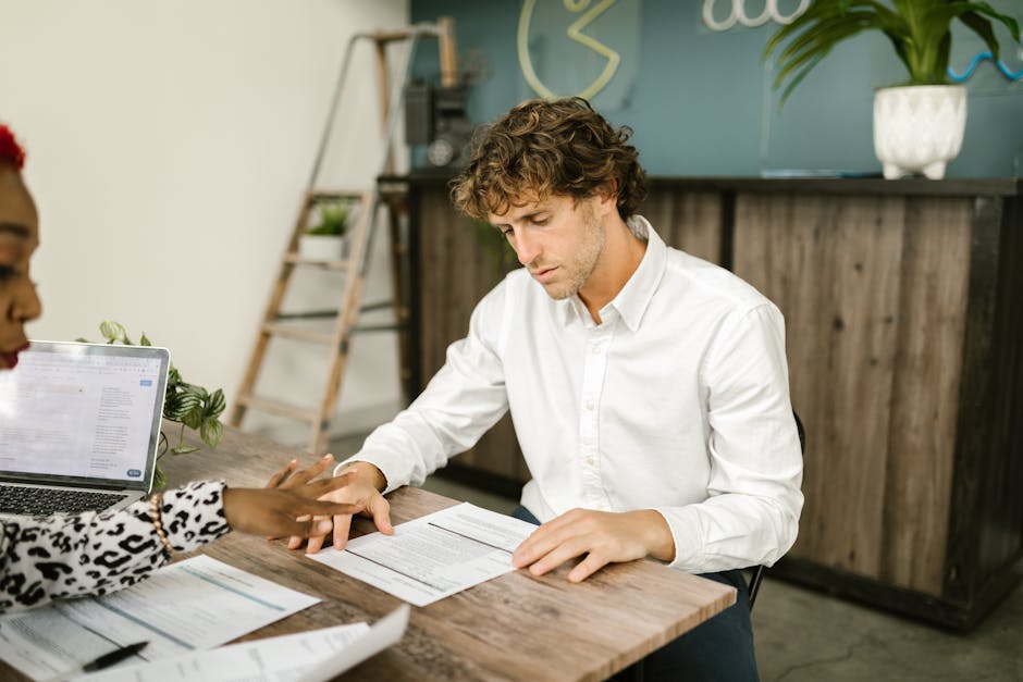 business team analyzing contract data on computer