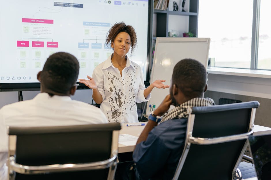 diverse team in a hybrid meeting with remote participants on screen