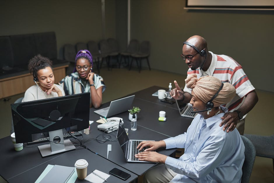 diverse team in office meeting with some members on video call