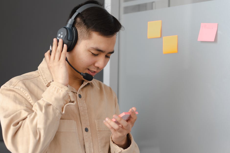 employee wearing headphones in crowded office