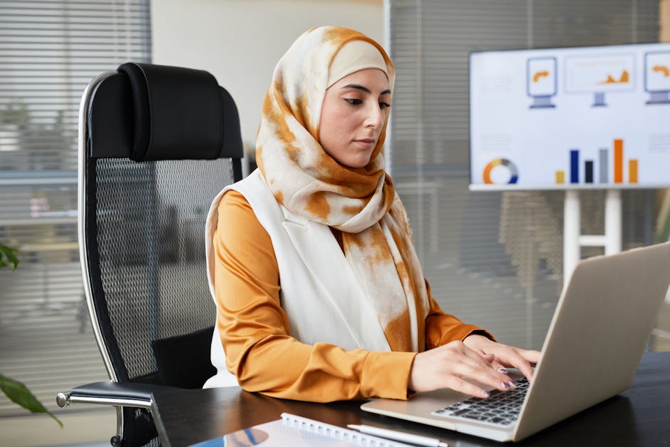 employee working on laptop with productivity charts