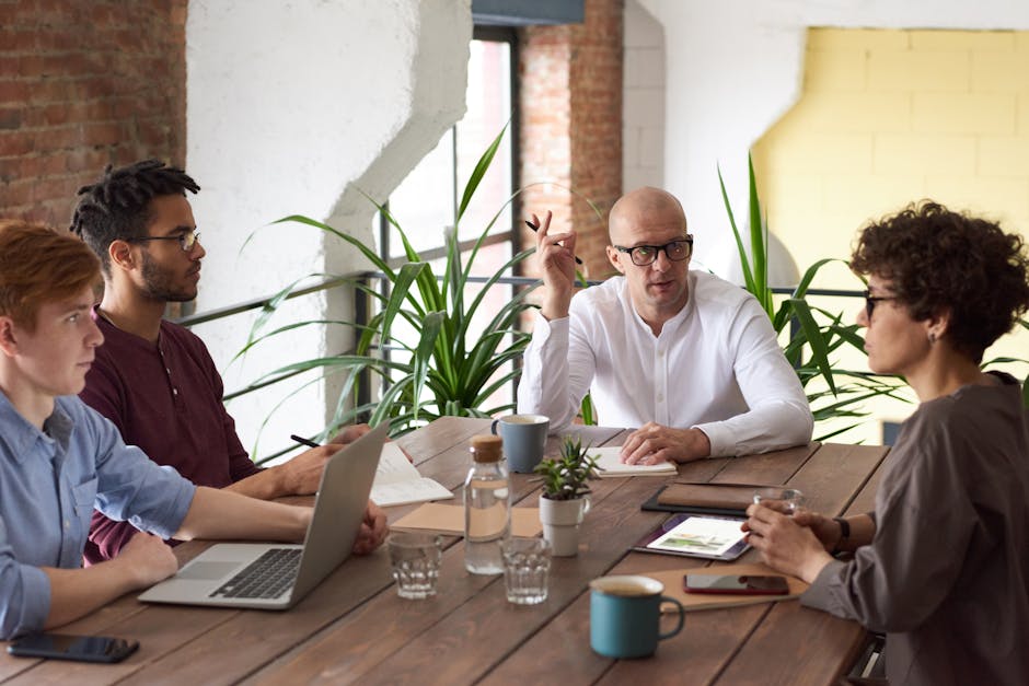 employees in a meeting room brainstorming