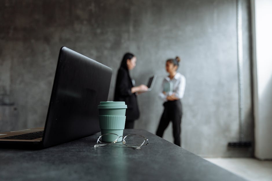 executive mentoring young employee in office setting