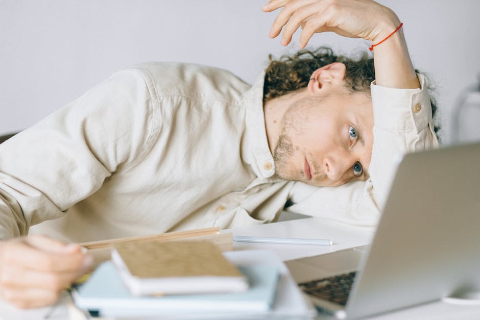 exhausted office worker at desk needing vacation