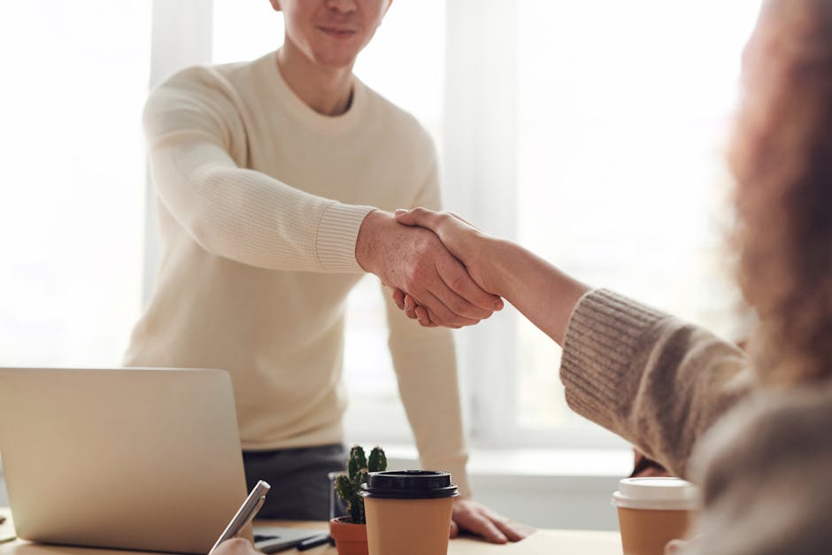 job candidate shaking hands with interviewer