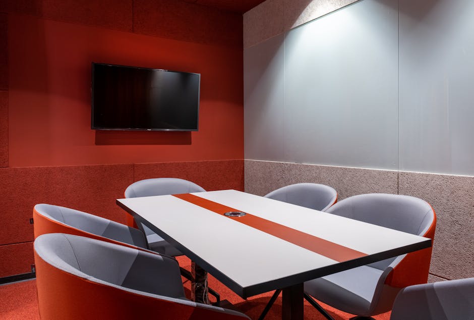 modern conference room with curved table and wall-mounted screens