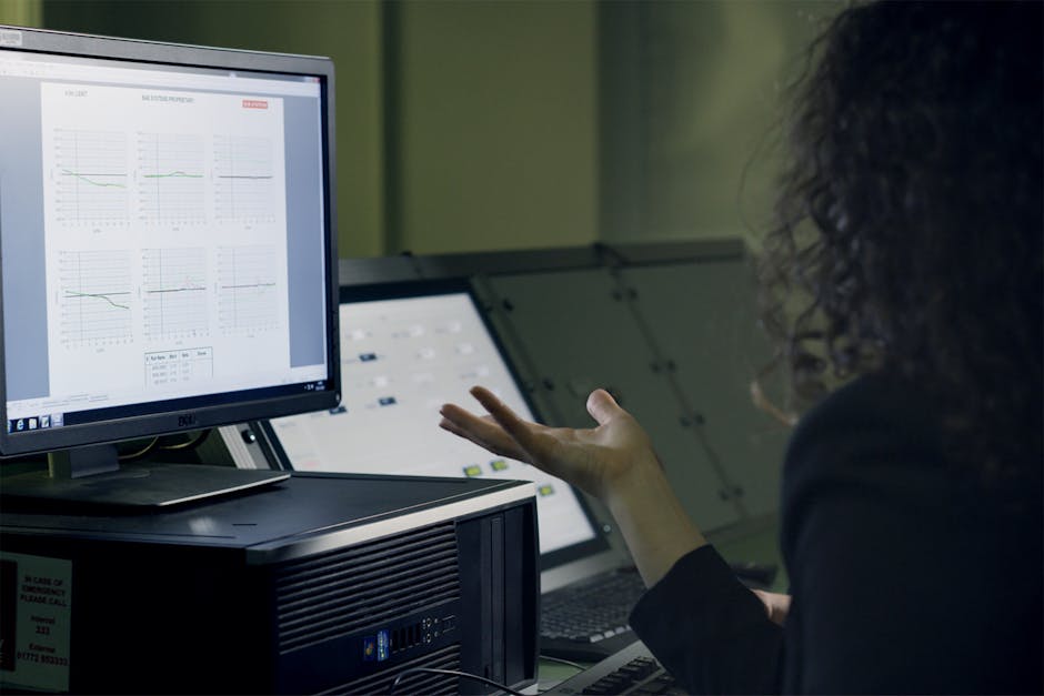 office workers analyzing data on computer screens