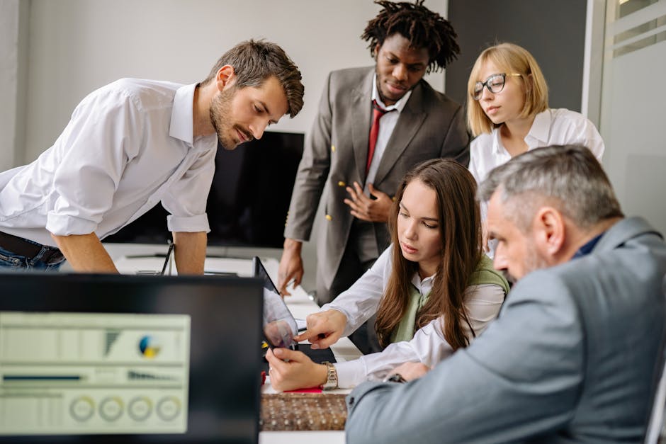 office workers checking digital meeting room schedule