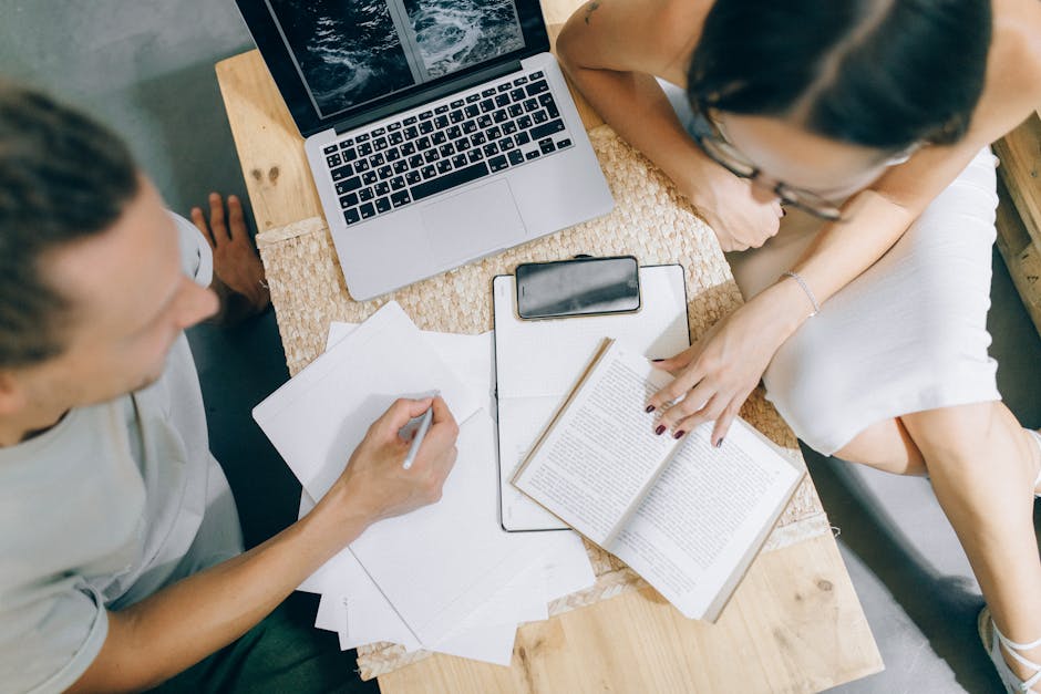 office workers collaborating at shared desk space