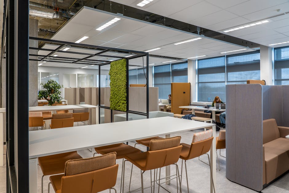 open office space with various workstations and meeting areas