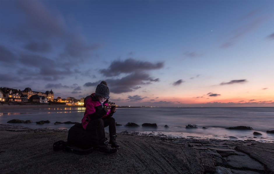 person relaxing on beach with phone