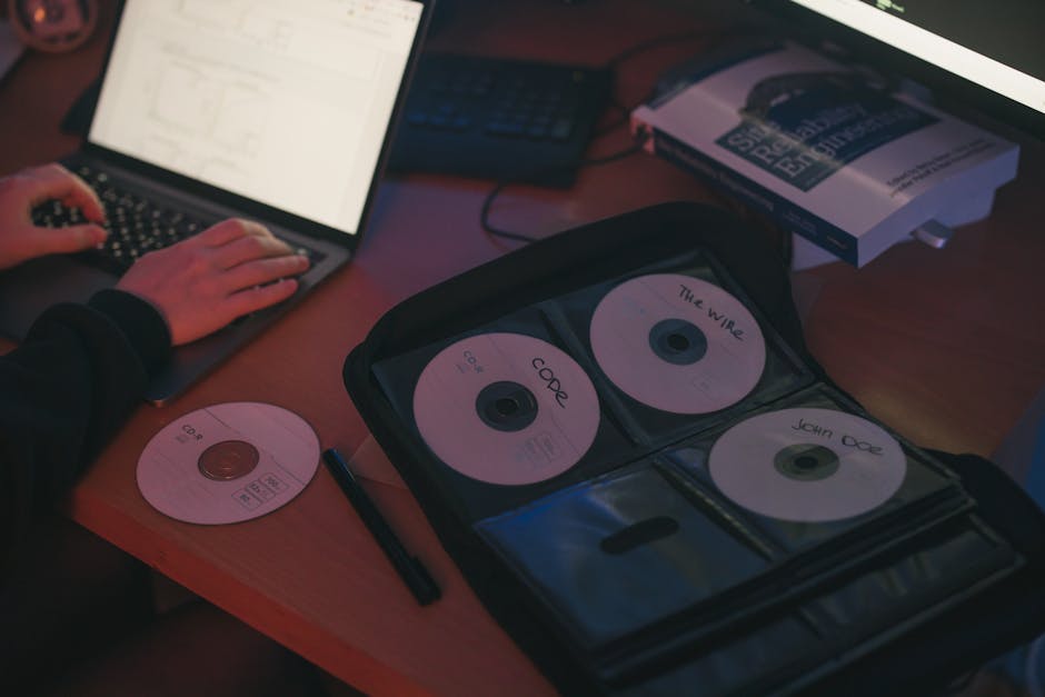 person using laptop with multiple digital tools