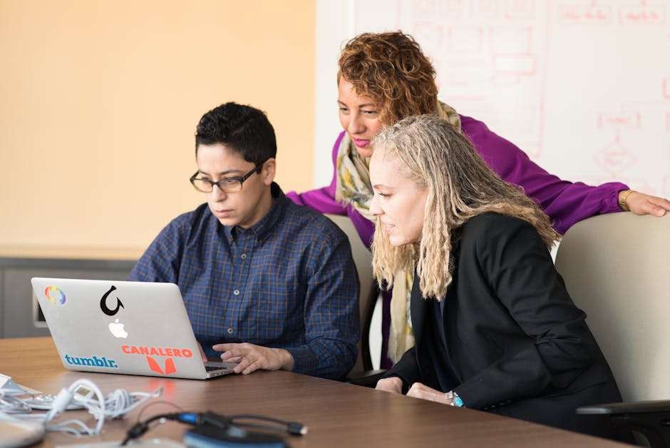 team meeting discussing workplace management software features